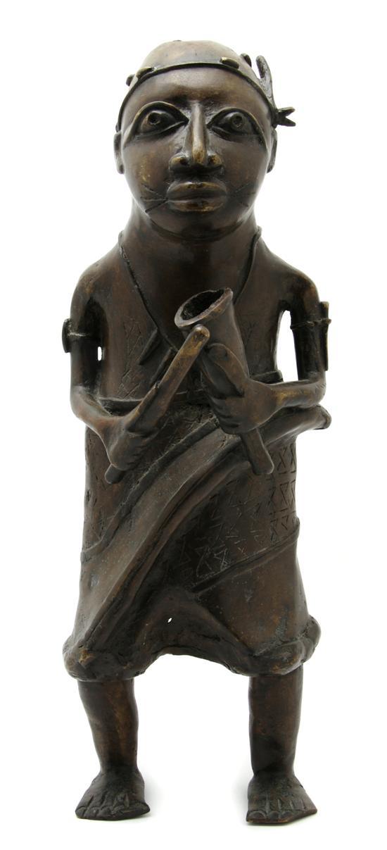 Appraisal: An African Bronze Figure Benin Style depicting a standing warrior