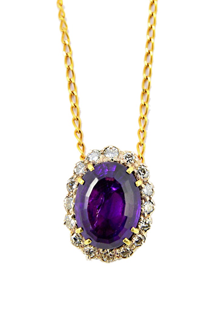 Appraisal: An amethyst and diamond set oval cluster pendant claw set