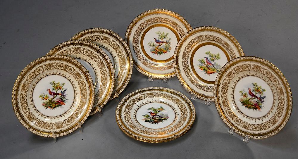 Appraisal: Eight Minton service plates with painted bird centers and ornate