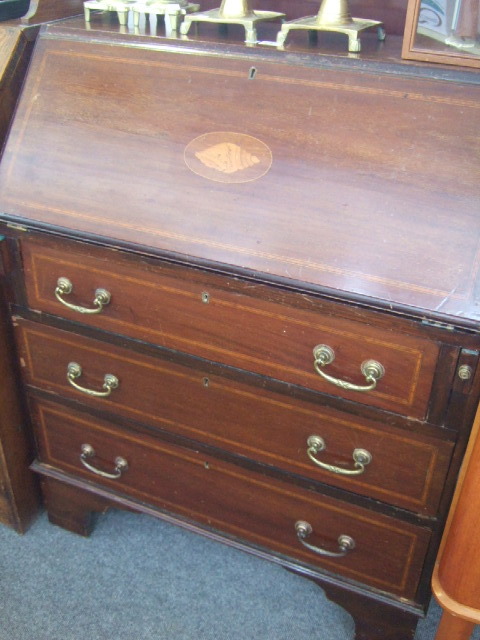 Appraisal: An Edwardian inlaid mahogany bureau the conch shell fall revealing