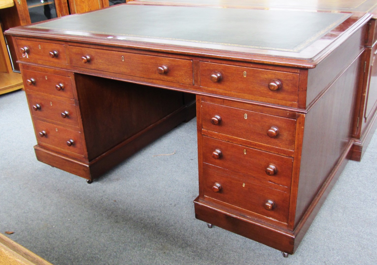 Appraisal: A th century mahogany pedestal desk with nine drawers about