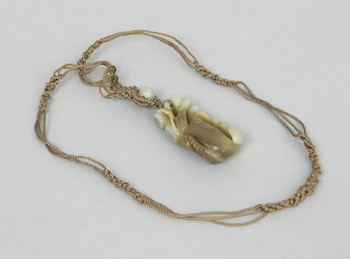 Appraisal: A Carved Jade Ornament Suspended from a Macrame Necklace A