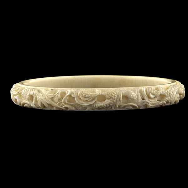 Appraisal: Chinese Carved Ivory Bangle African ivory a bangle bracelet deeply