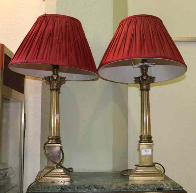 Appraisal: A PAIR OF BRASS TABLE LAMPS with corinthian column supports