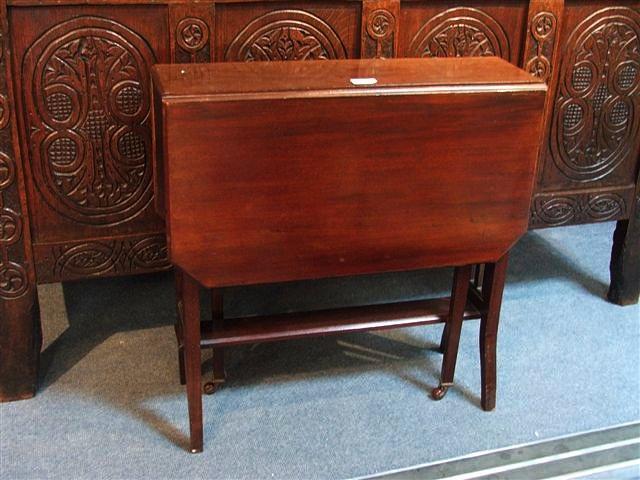 Appraisal: AN EDWARDIAN RECTANGULAR MAHOGANY SUTHERLAND TABLE the top with canted