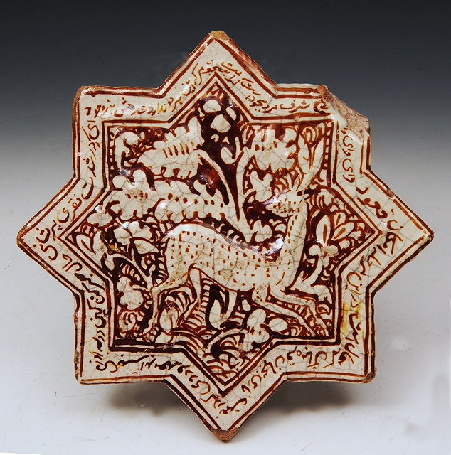 Appraisal: AN ISLAMIC STAR SHAPED TILE with monochrome stag and foliate