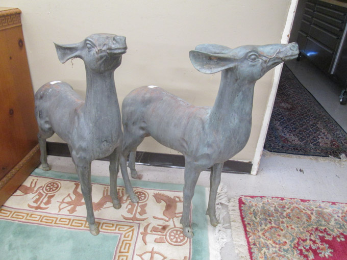 Appraisal: A PAIR OF PATINATED BRONZE YARD DEER featuring two identical