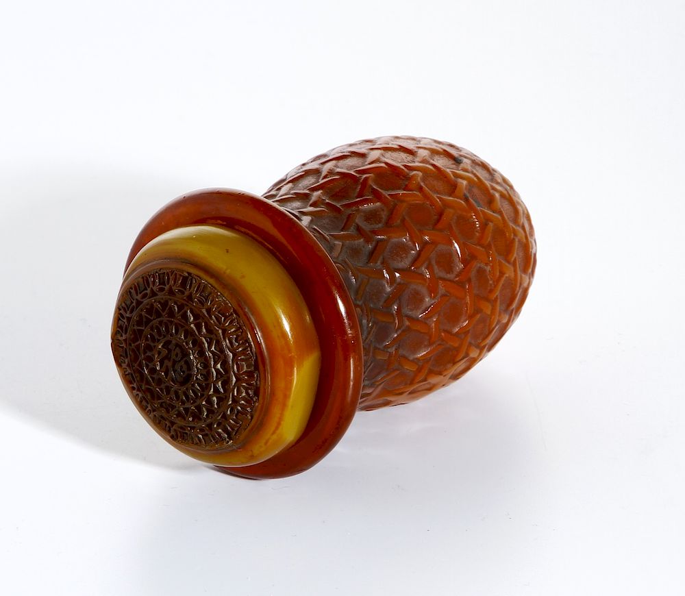 Appraisal: Chinese Carved Cricket Cage Possibly amber with deep pointed body