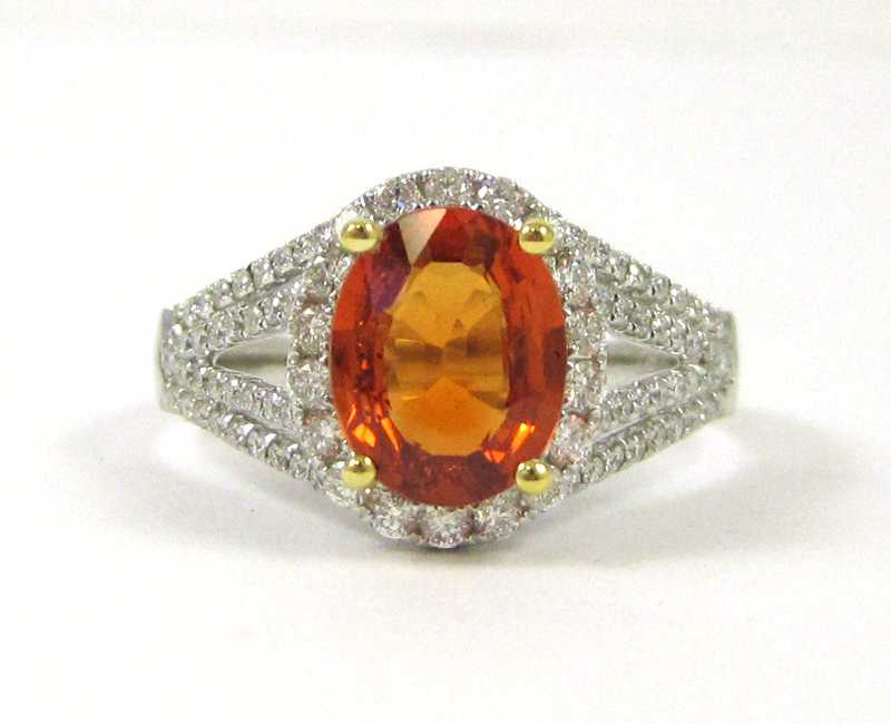 Appraisal: ORANGE SAPPHIRE DIAMOND AND EIGHTEEN KARAT GOLD RING The white