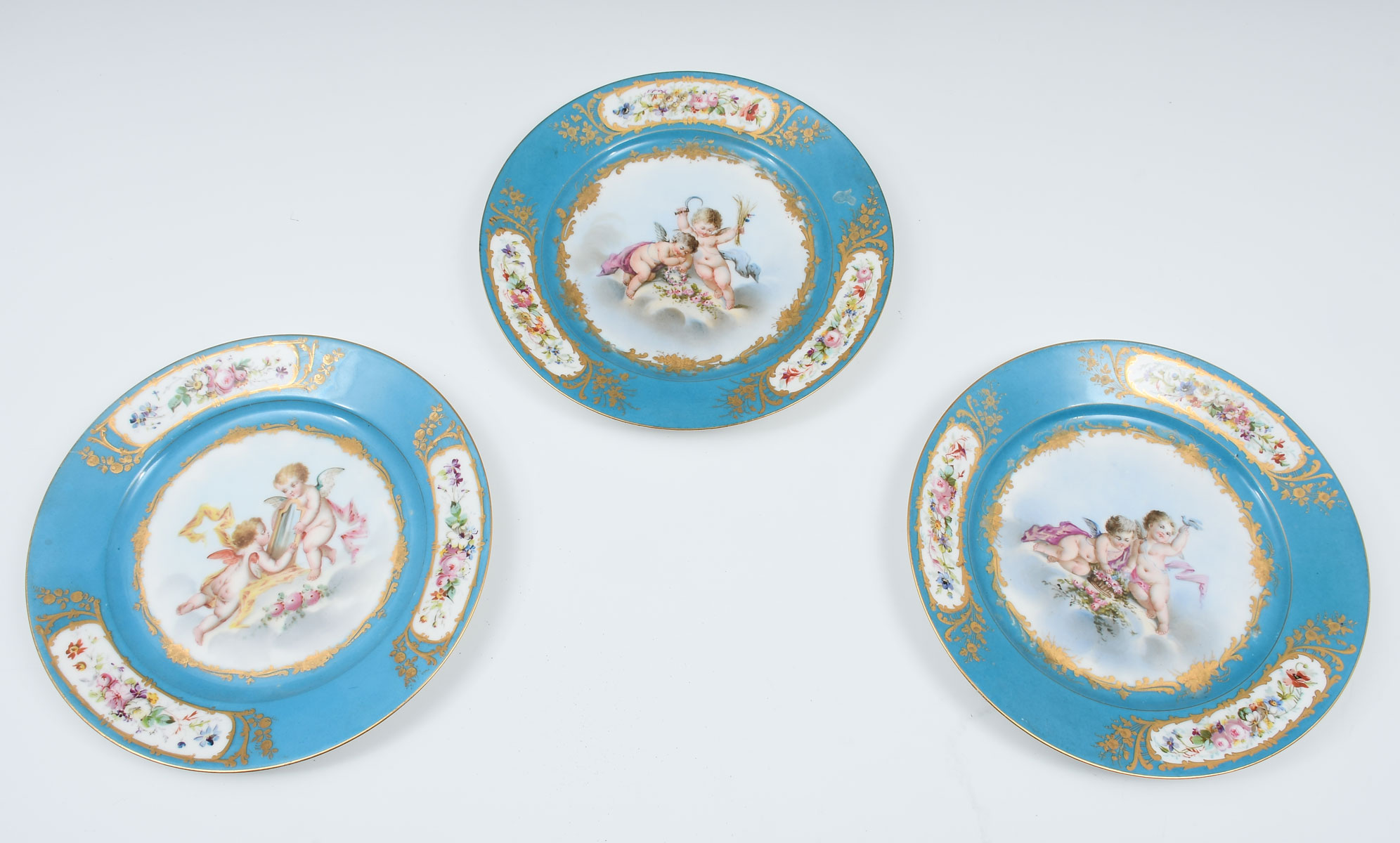 Appraisal: SEVRES STYLE CHERUB PLATES Sevres style plates having blue ground