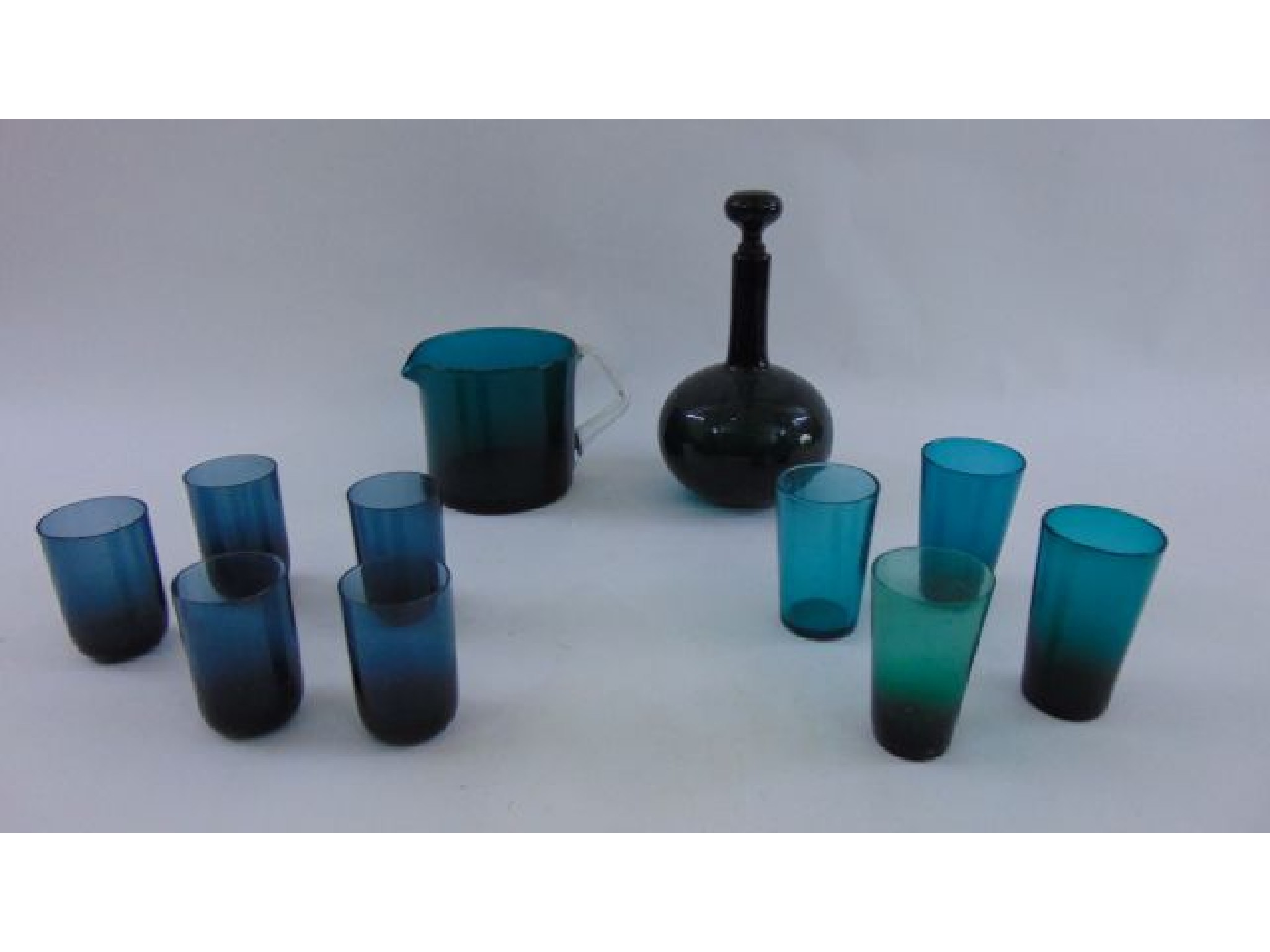 Appraisal: A collection of green glass tumblers a further jug with