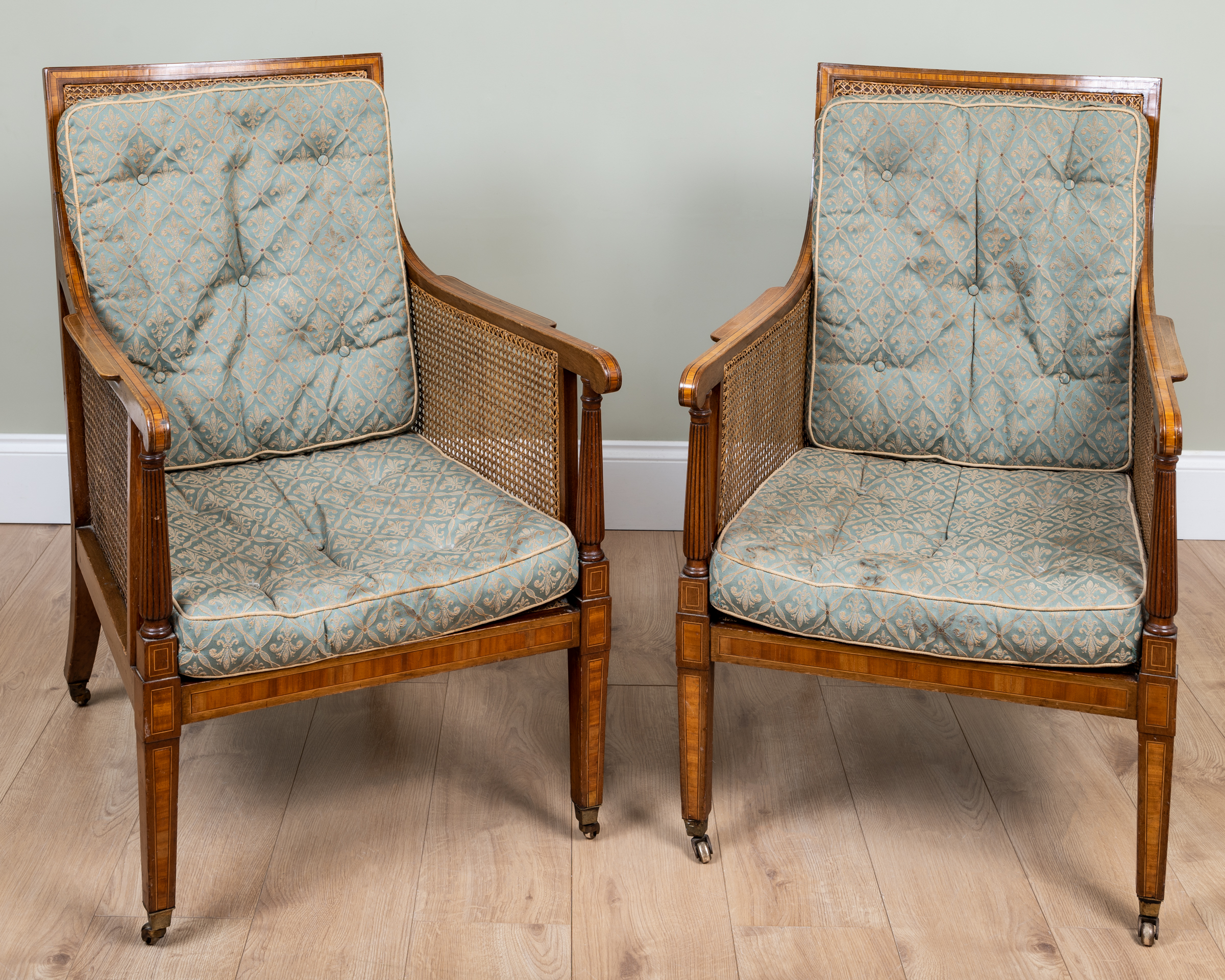 Appraisal: A pair of th century mahogany Bergere library armchairs with