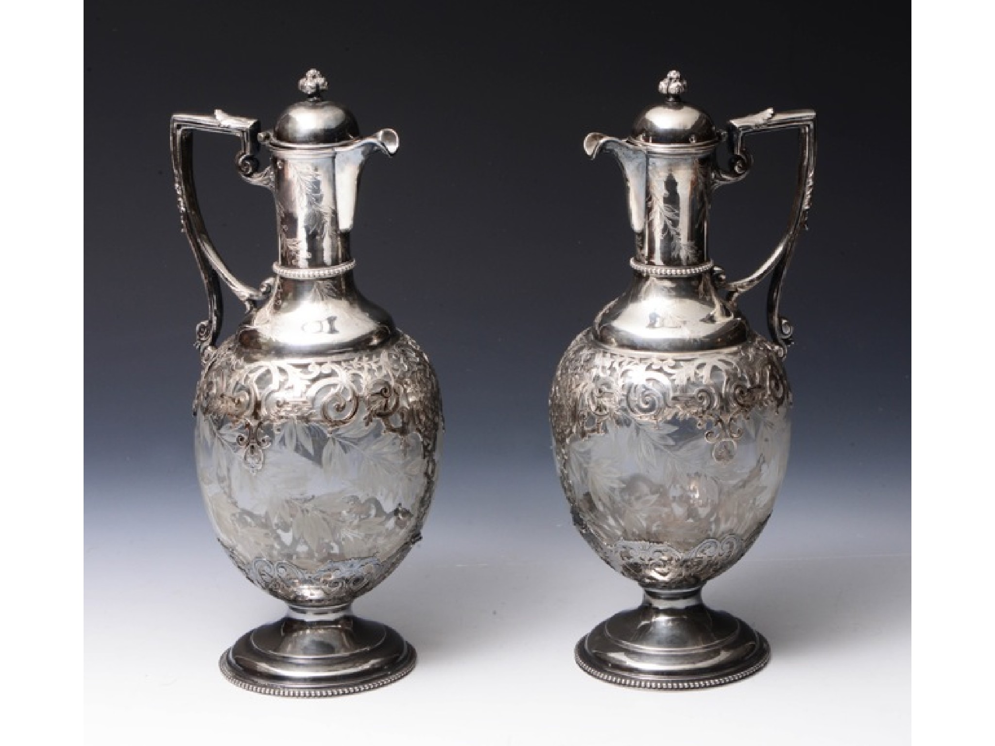 Appraisal: A pair of French silver-mounted glass claret jugs standard each