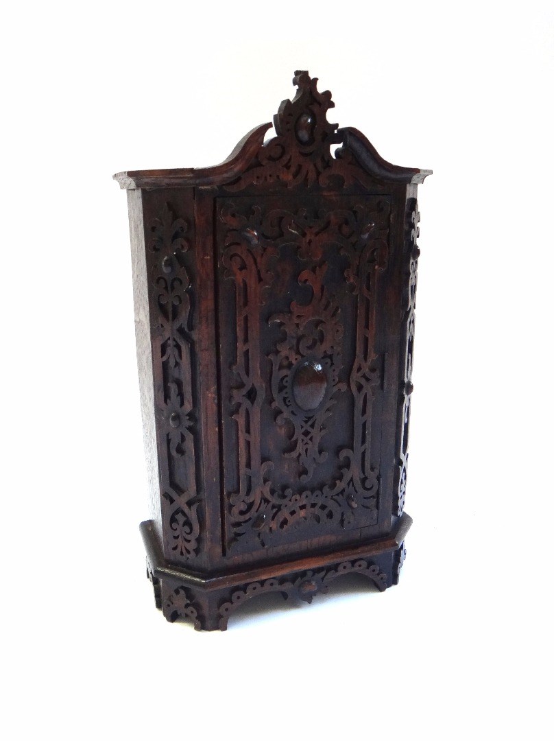 Appraisal: A miniature oak armoire with allover blind fret decoration and