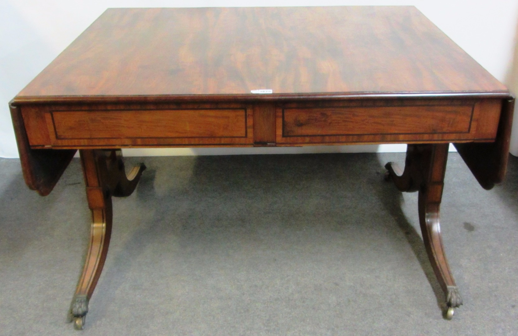 Appraisal: An early th century large mahogany sofa table with shaped