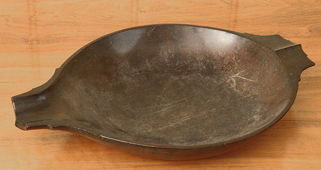 Appraisal: A FIJIAN SHALLOW CARVED WOODEN DISH with shaped handle and