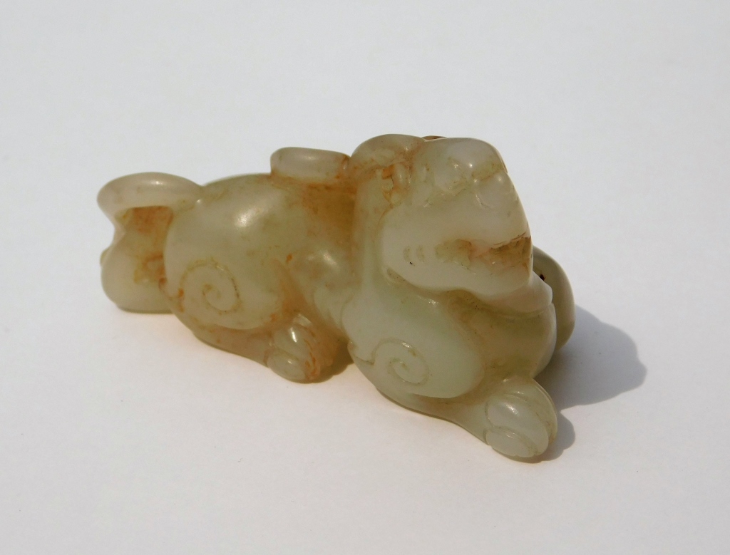 Appraisal: CHINESE QING DYNASTY CARVED JADE RECUMBENT DRAGON China Qing DynastyDepicts