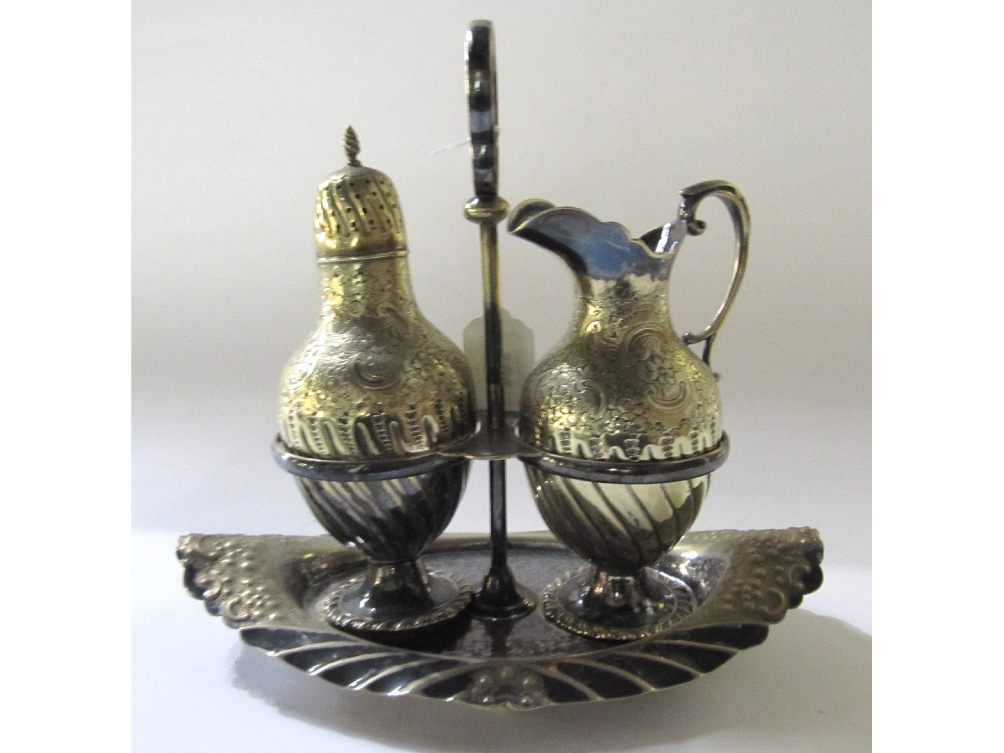 Appraisal: A silver plated cream jug and sugar castor on stand