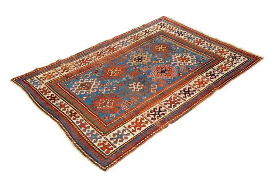 Appraisal: ORIENTAL RUG Caucasian Ivory border and blue ground Minor wear