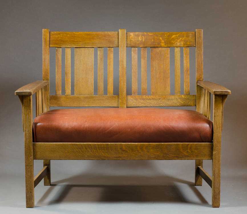 Appraisal: CRAFTSMAN OAK DOUBLE CHAIR-BACK SETTEE American c with drop-leaf leather