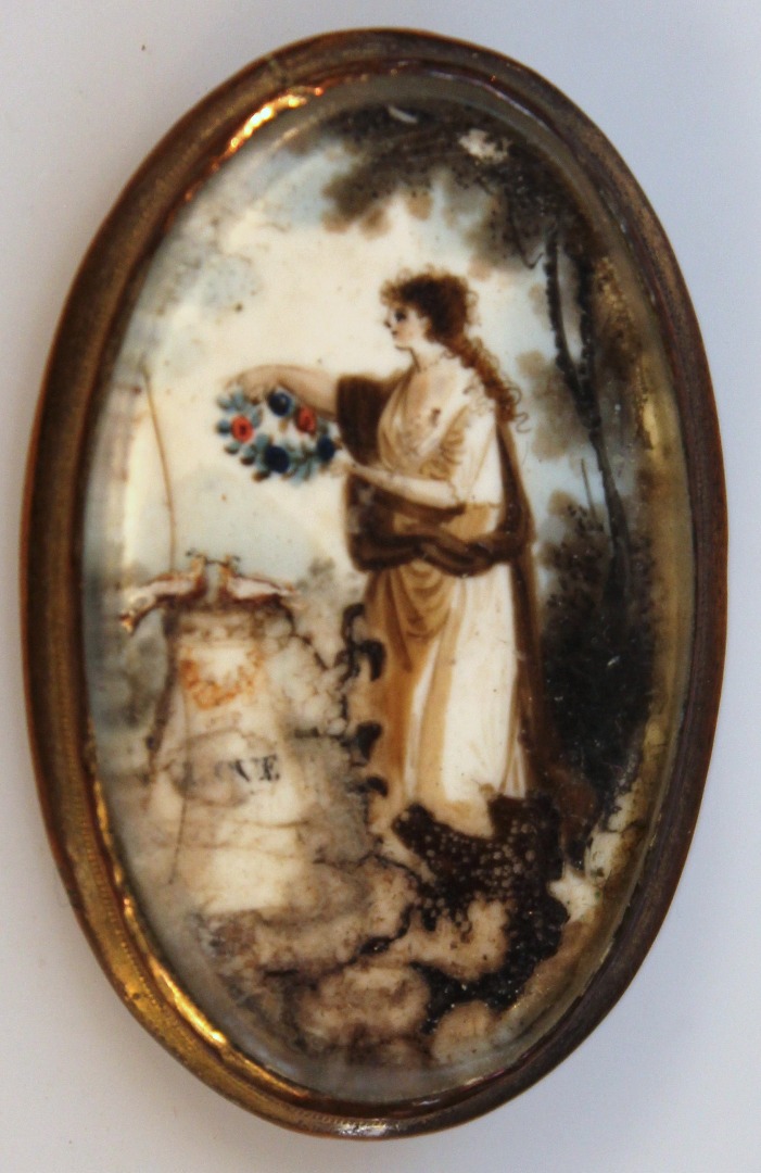 Appraisal: A pendant brooch the oval body decorated in miniature with