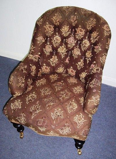 Appraisal: A Victorian stained beech framed armchair with button back and