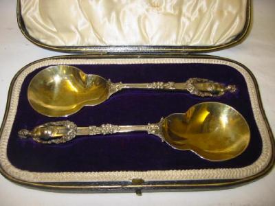 Appraisal: A PAIR OF SERVING SPOONS with gilded and waisted bowl