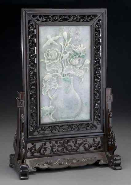 Appraisal: Chinese carved jadeite table screendepicting lotus blossoms birds and a