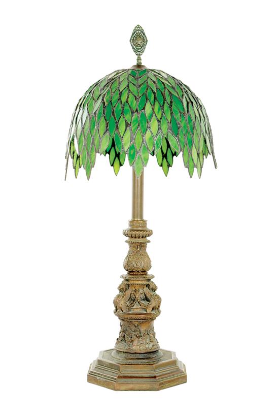 Appraisal: Bronze figural lamp with leaded glass shade early th century