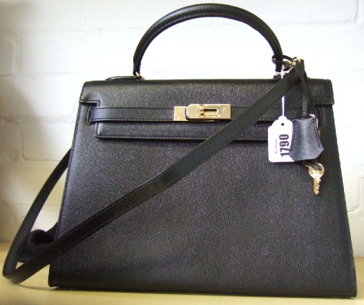 Appraisal: A Hermes 'Kelly' leather handbag with brass embellishments with dust