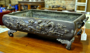 Appraisal: A Japanese bronze rectangular jardiniere decorated with a dragon and