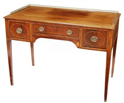 Appraisal: A mahogany dressing table the top with a pierced brass