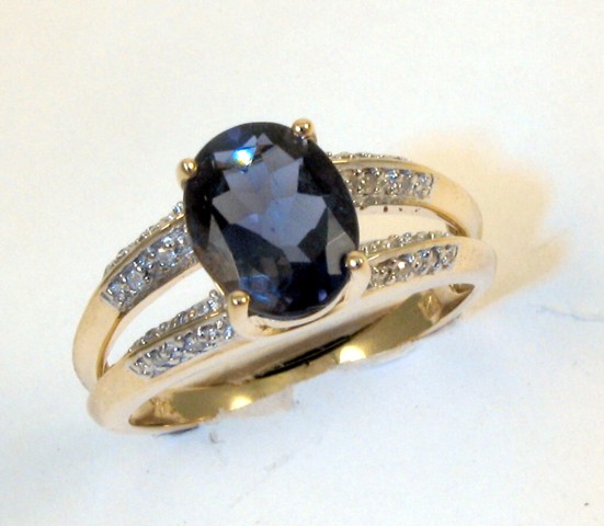 Appraisal: IOLITE DIAMOND AND FOURTEEN KARAT GOLD RING centering an oval-cut