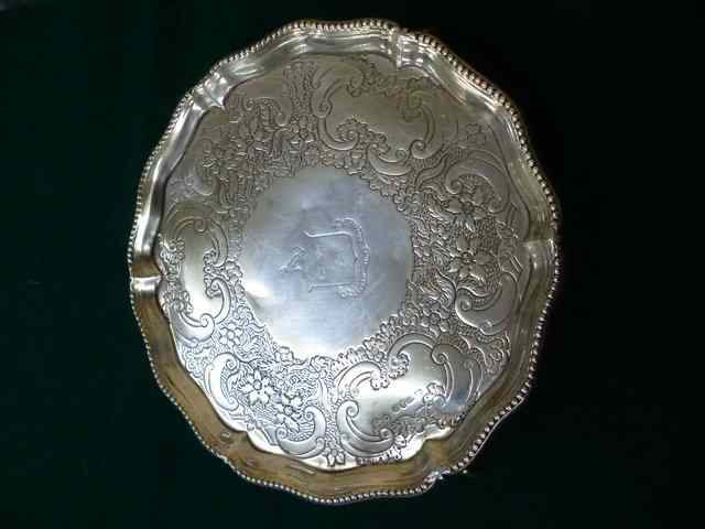 Appraisal: A GEORGIAN SILVER SALVER with later chased and engraved decoration