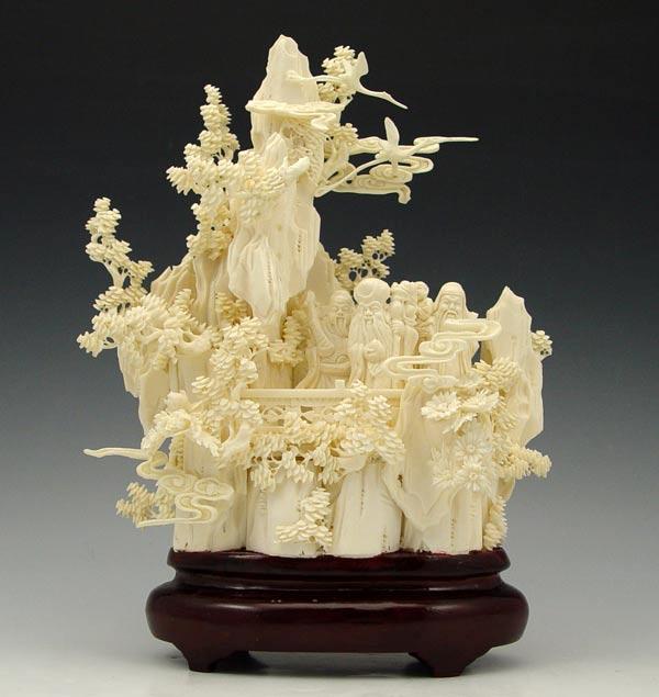 Appraisal: BONE LANDSCAPE CARVING WITH FIGURES Intricate carving of figures in