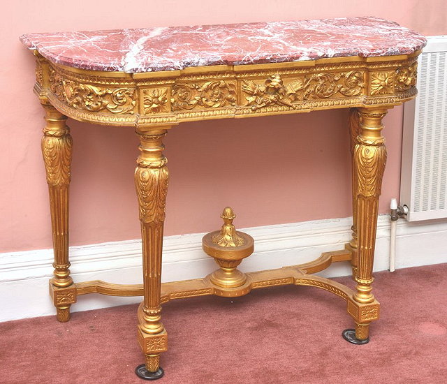 Appraisal: A FRENCH GILTWOOD CARVED CONSOLE TABLE with marble top late