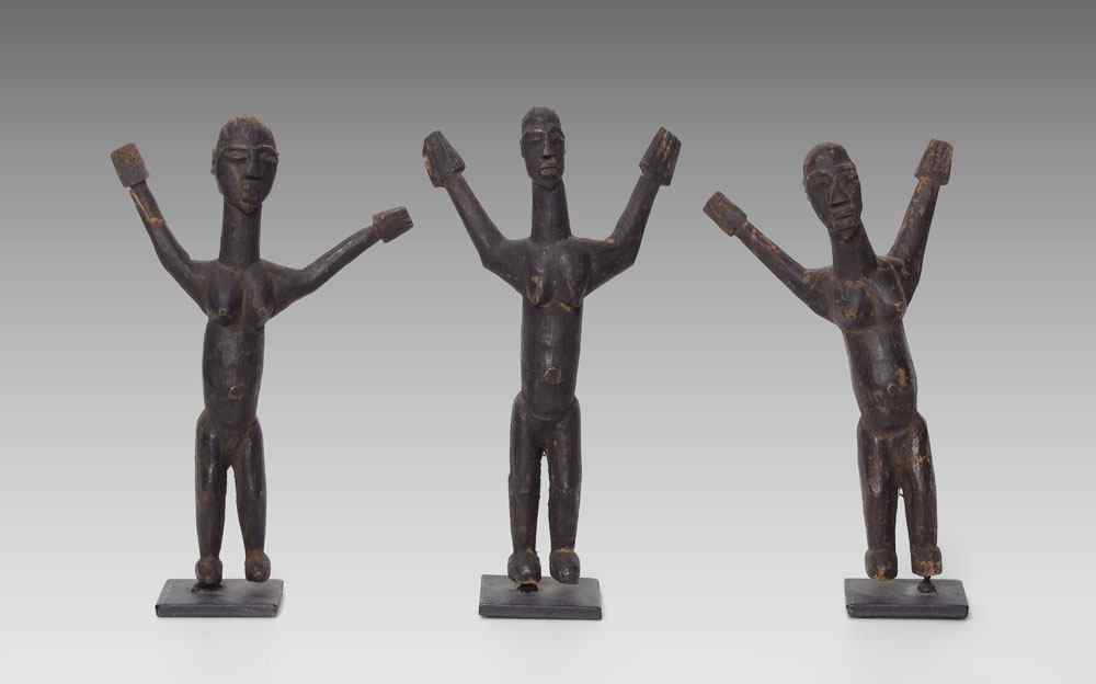 Appraisal: OCEANIC CARVED FIGURES Each approx ''h mounted on metal base