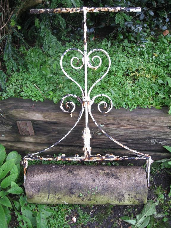 Appraisal: A stone Garden Roller with decorative white painted wrought iron