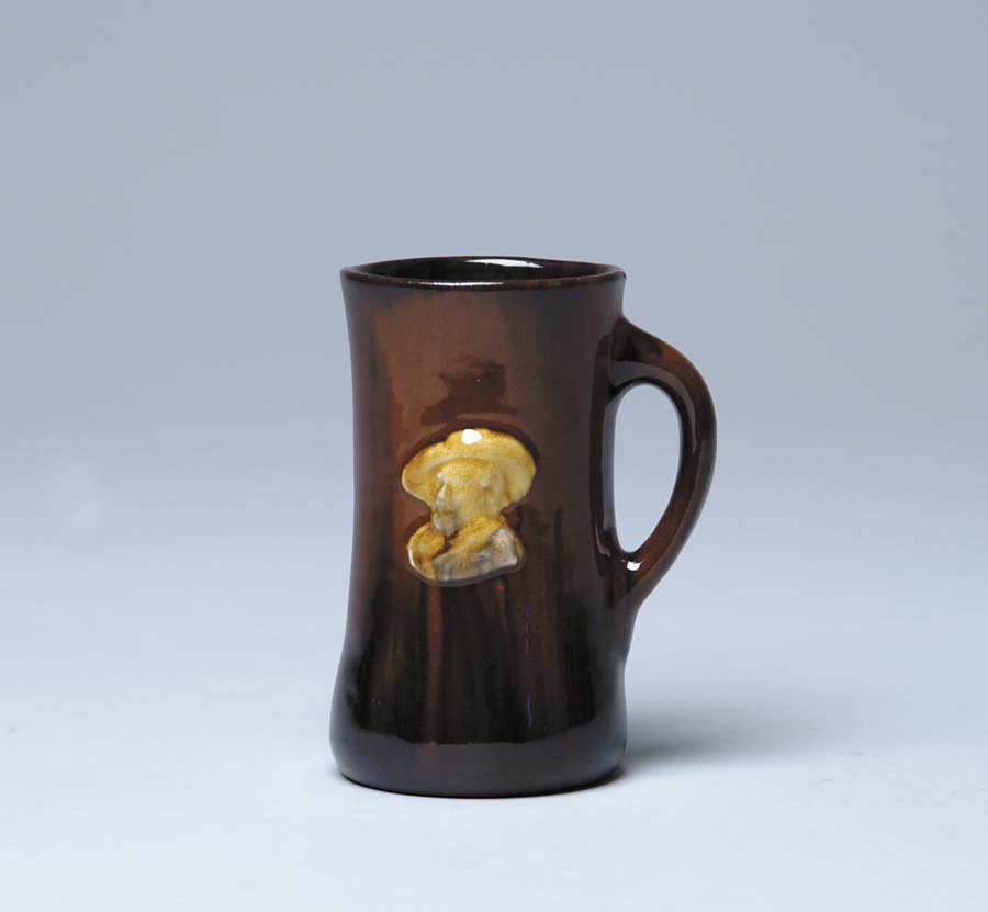 Appraisal: ART POTTERY MUG Attributed to Peters Reed Brown mug with