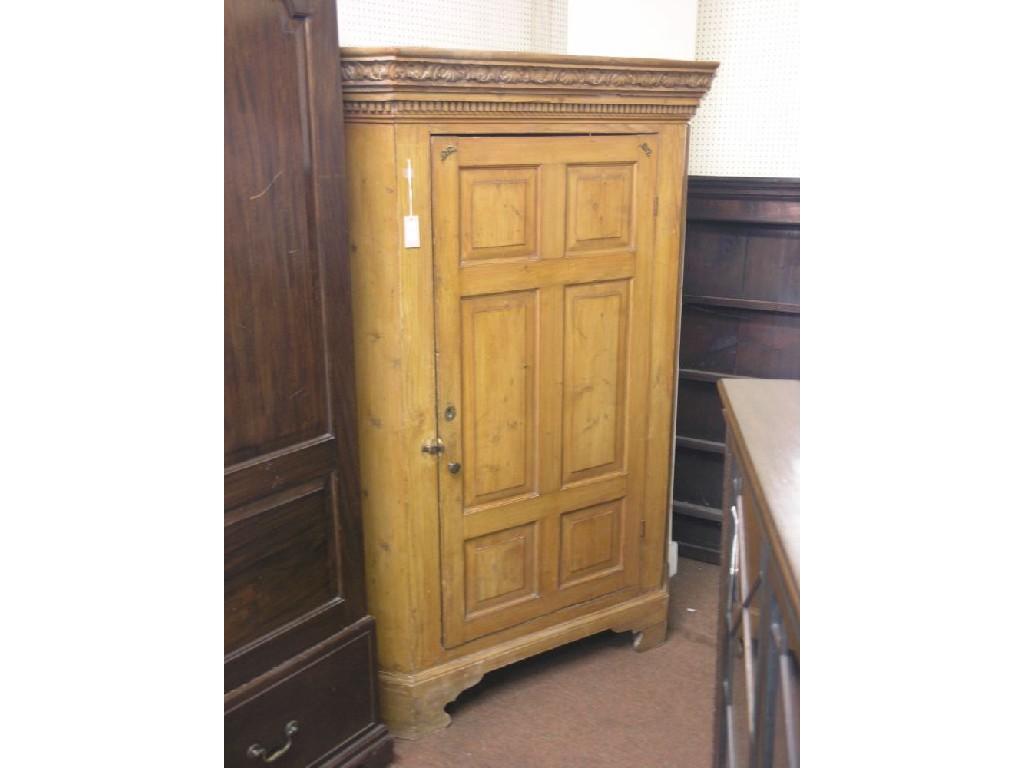 Appraisal: A th century continental pine corner cupboard floor-standing pediment carved