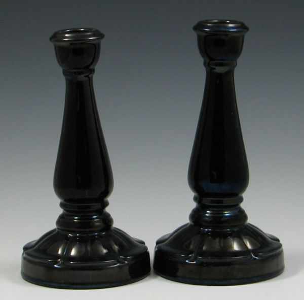 Appraisal: Two Peters and Reed Mirror Black Candlesticks left is unmarked