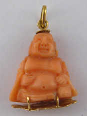 Appraisal: A yellow metal tests carat gold carved coral Buddha pendant