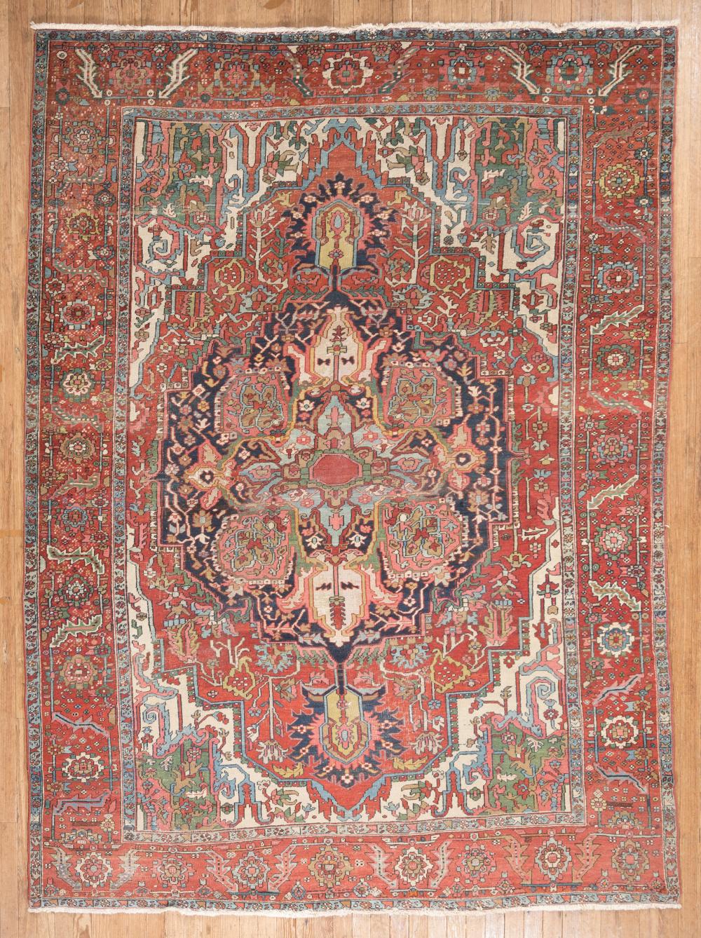 Appraisal: Heriz Rug central medallion red ground overall stylized floral design