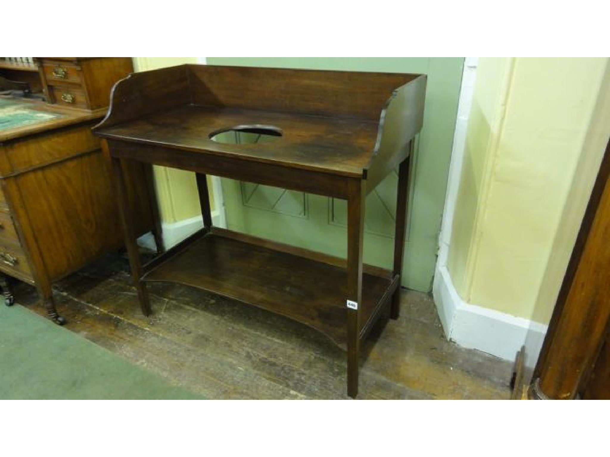 Appraisal: A Georgian mahogany washstand of simple form with raised three