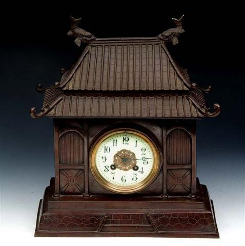 Appraisal: A BRONZE CHINESE PAGODA CLOCK with fish finial 'tiled' roof