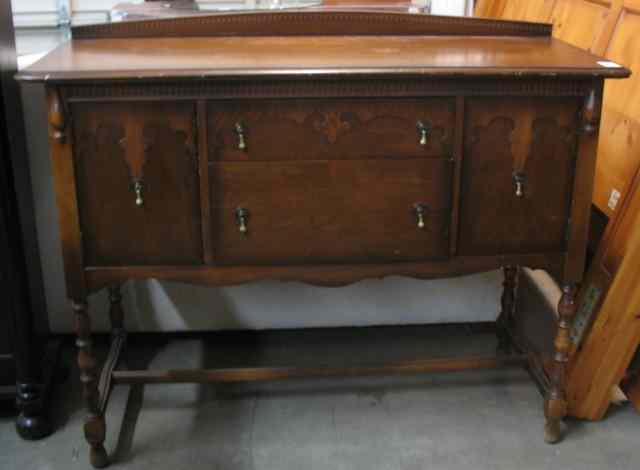 Appraisal: PETITE WALNUT BUFFET American c 's the front featuring two