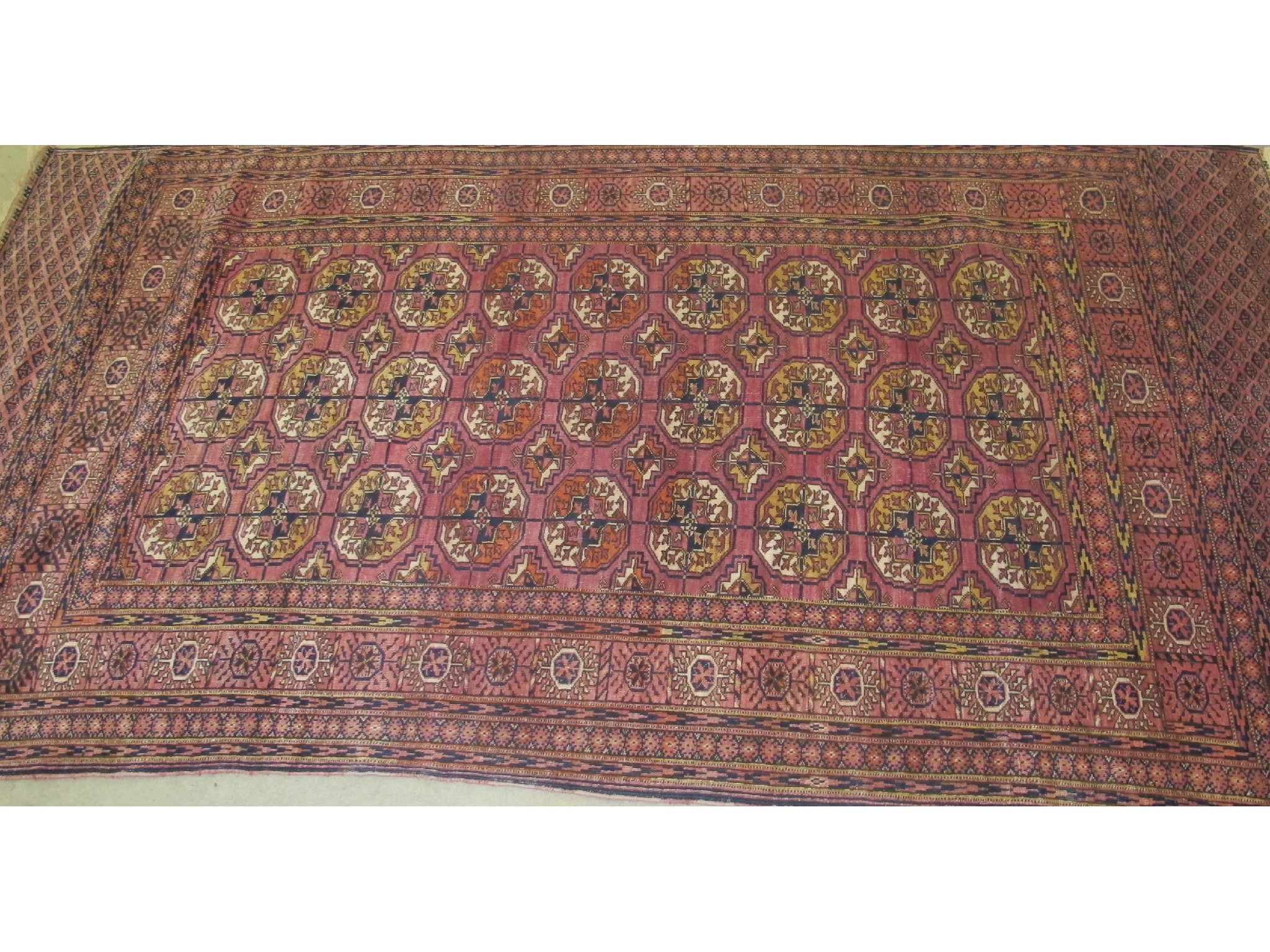 Appraisal: An Eastern floor rug on a blue and pink ground