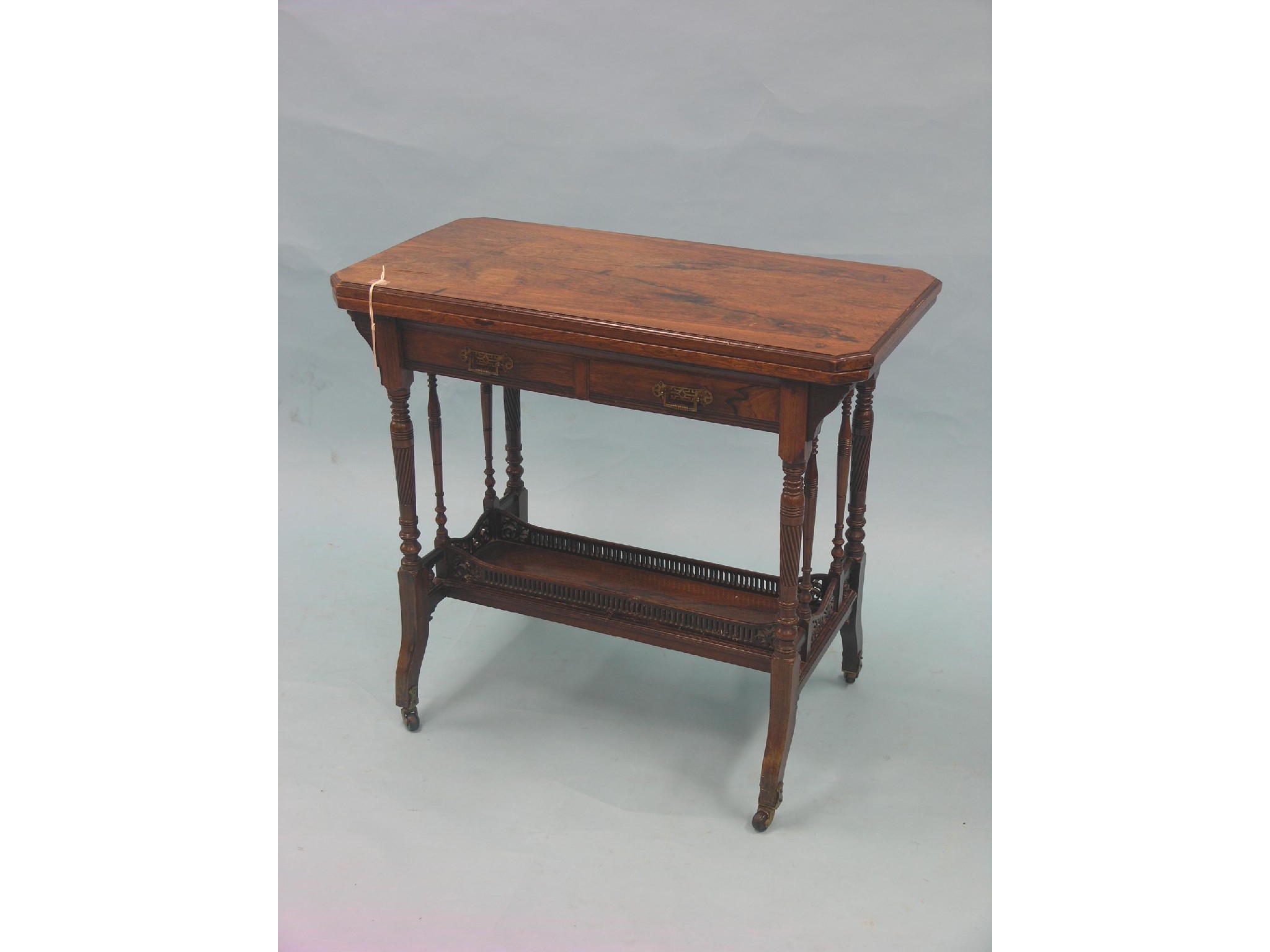 Appraisal: A late Victorian rosewood card table rectangular-shape with cut corners