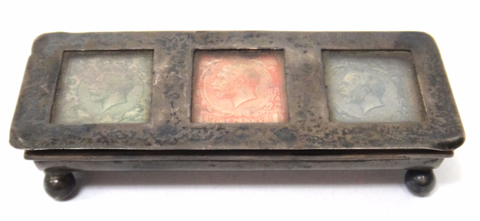 Appraisal: A silver hinge lidded triple compartment postage stamps box glazed