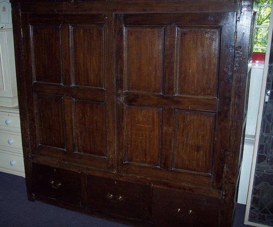 Appraisal: An oak wardrobe fitted for hanging enclosed by a pair